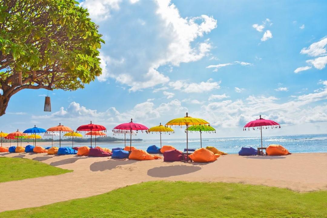 Різнокольорові парасольки та м'які пуфи на пляжі